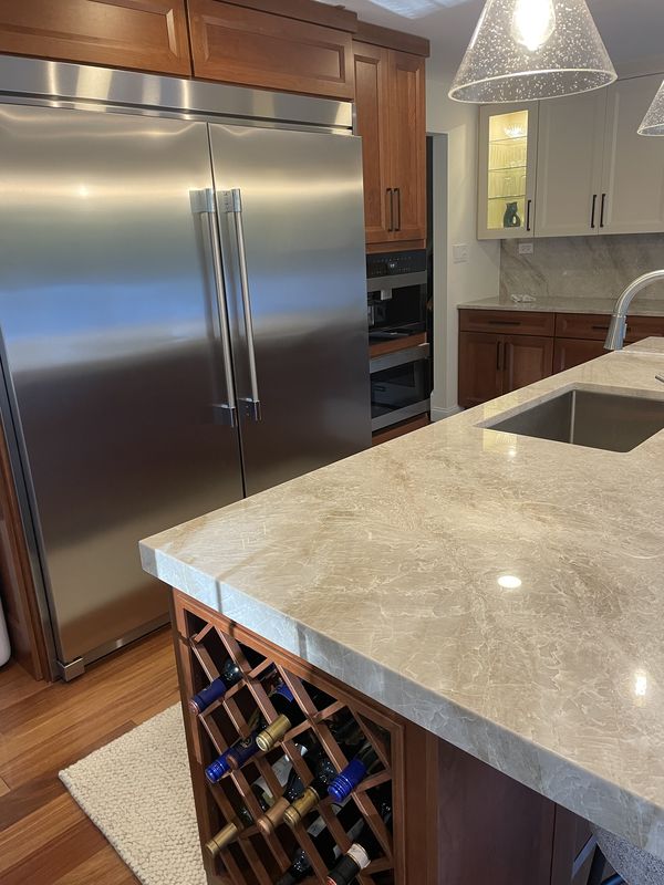 Built-in side-by-side refrigerator and the wine-rack corner of the island